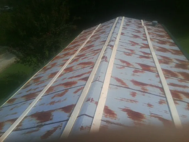 Rusted metal roof panels with new wood purlins before replacement — Storm Damage Roof Repair in Morral by Roofing Brothers